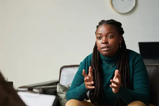 Woman speaking and gesturing during a therapy session